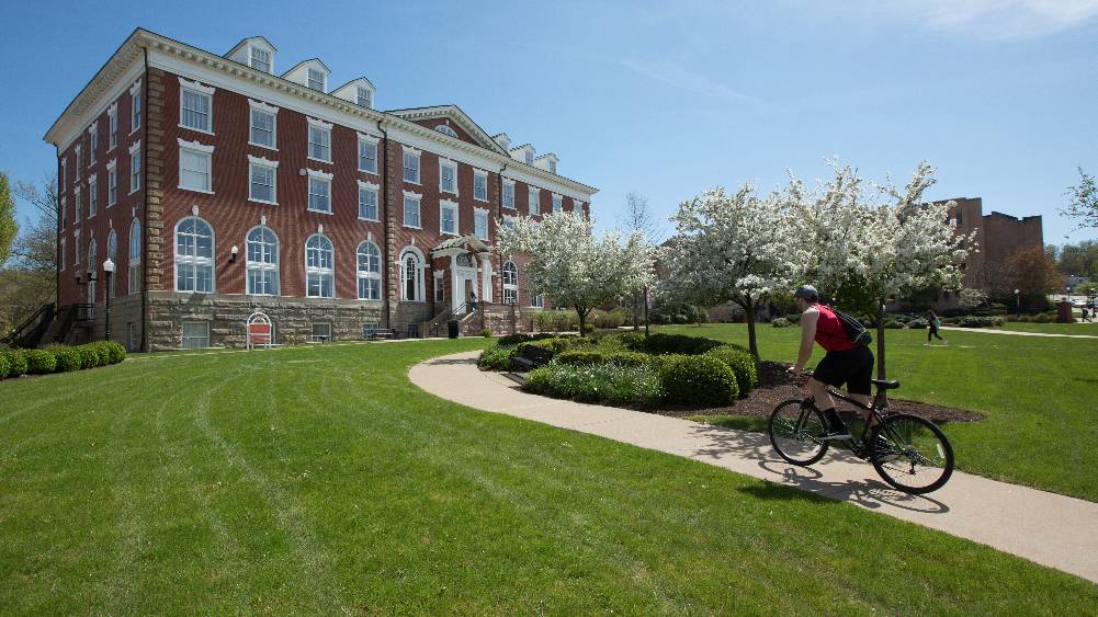 A PennWest California student rides his bike on campus.