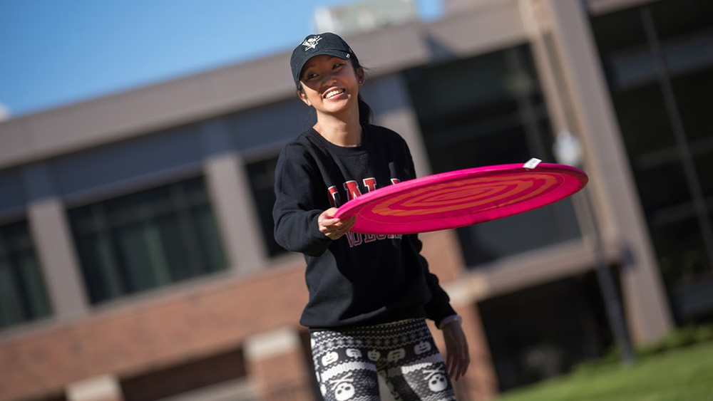 A PennWest California student throws a frisbee.