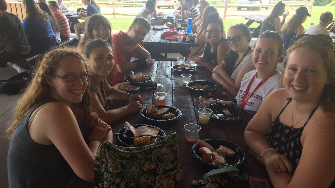 Honors Program students sit in an outdoor pavilion to eat.