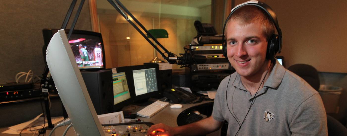A PennWest California student interns at a radio station.