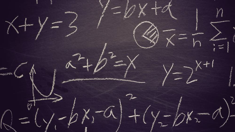 A chalkboard with math equasions.