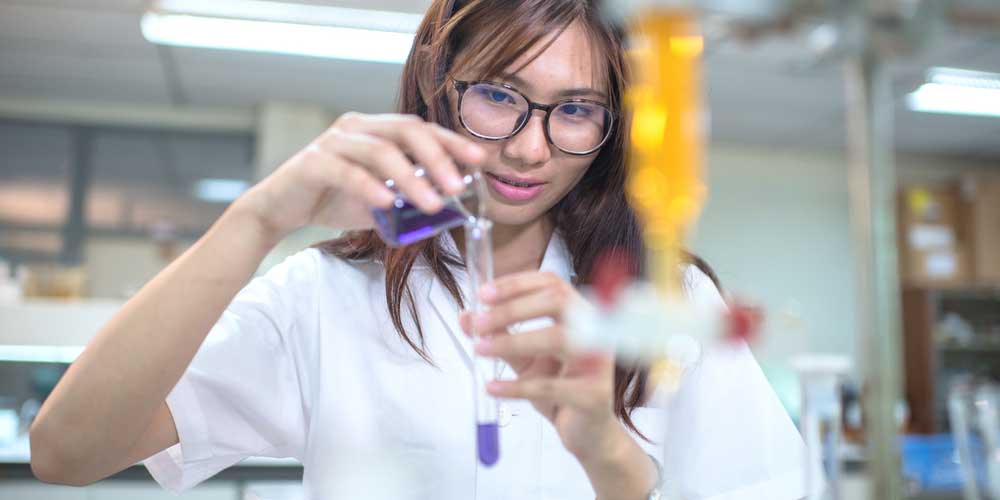A pharmacy student works in a lab.