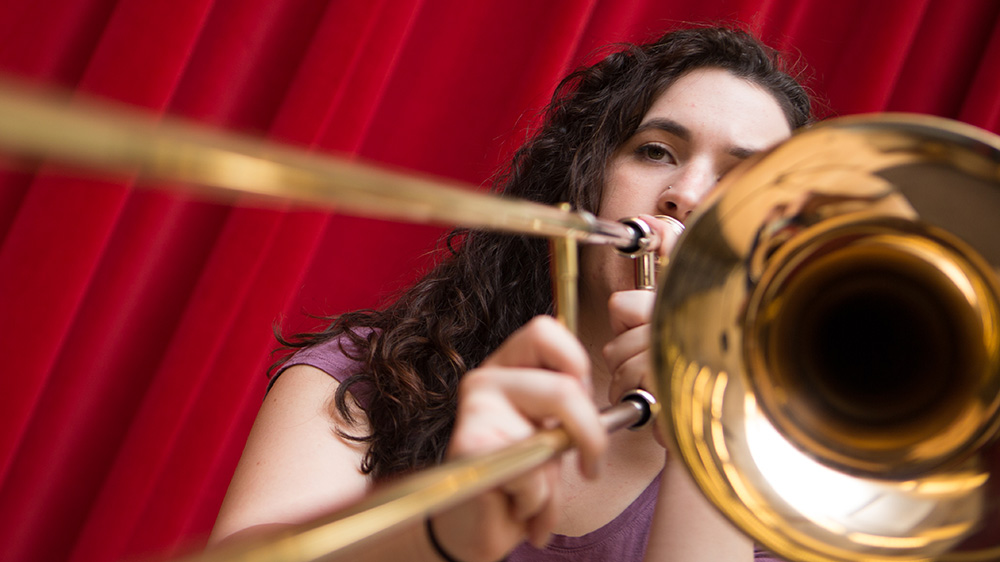 A PennWest California student play the trombone.